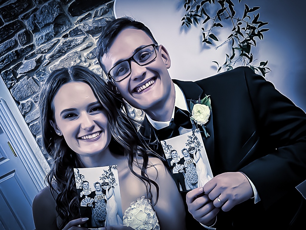 Maryland's Premium Photo Booth Rental a young couple holding a photo booth print and very happy. Photo booth Pasadena MD