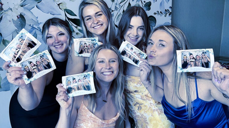 photo booth rental packages group of girls posing with custom photo booth templates