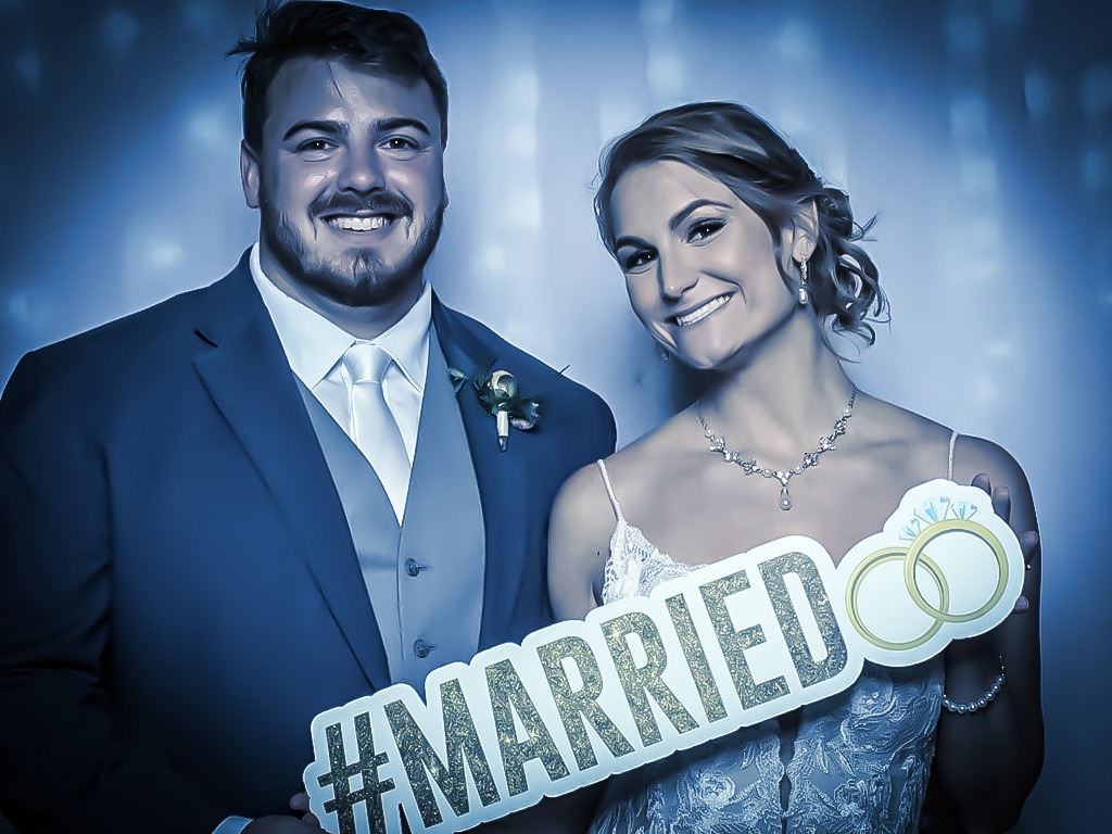 newly wed couple posing for a photo booth