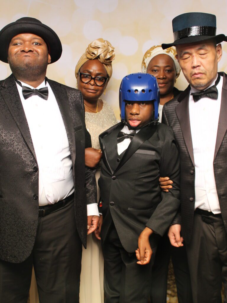 adutlts with disabilities posing at photo booth
