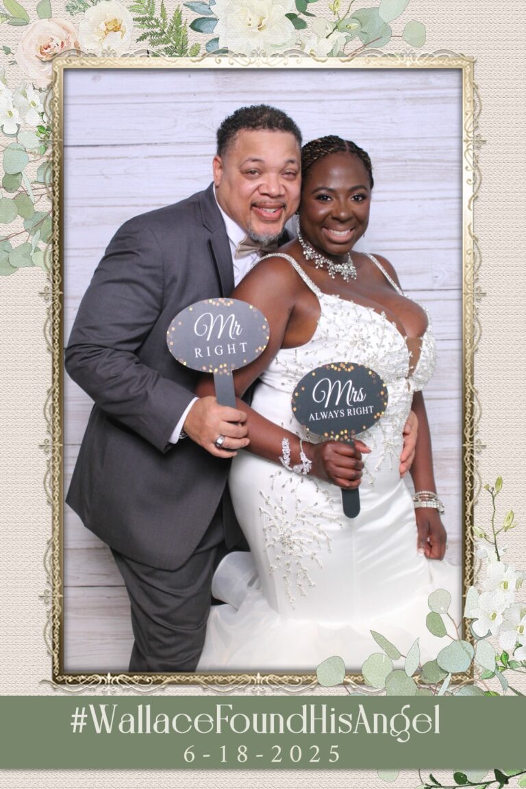 bride & groom pose for photo at mirror booth