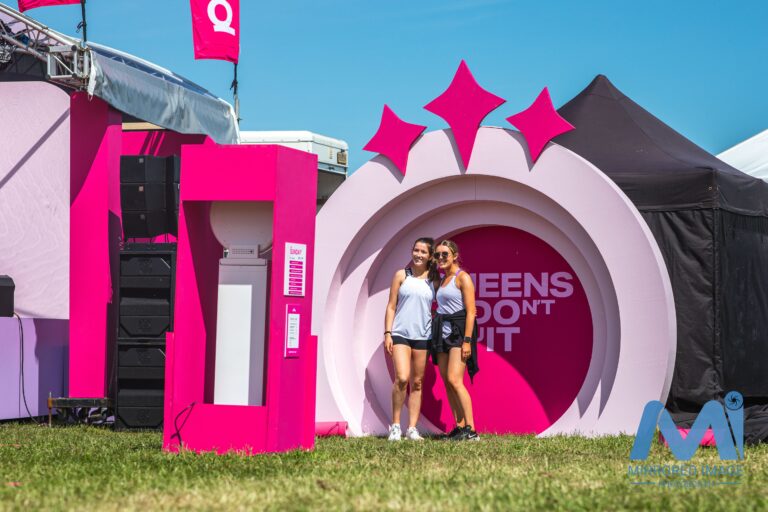 guest taking photos at branded booth at outside event