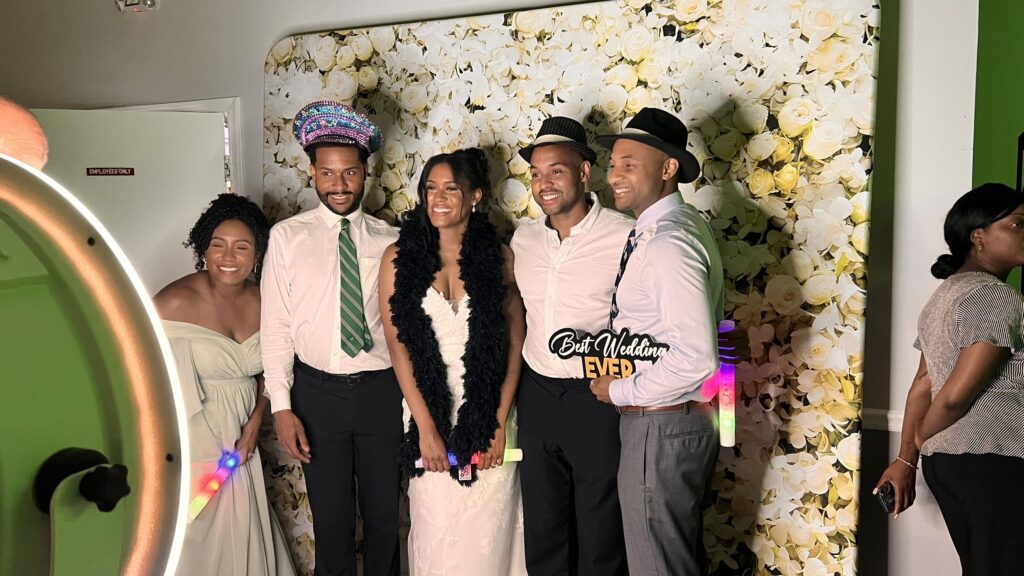 bride with guests at photo booth