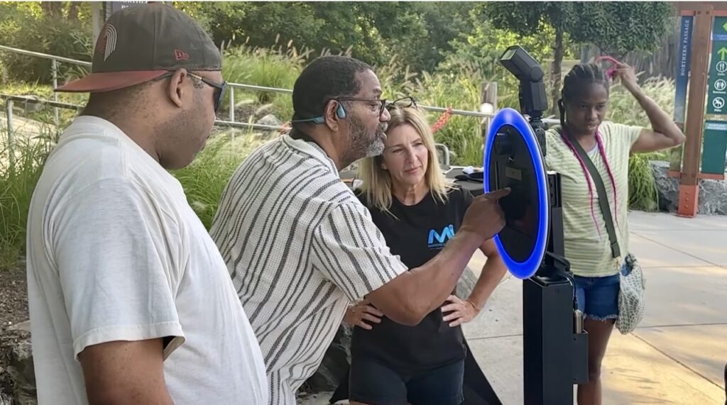 guest at selfie booth texting image to his phone