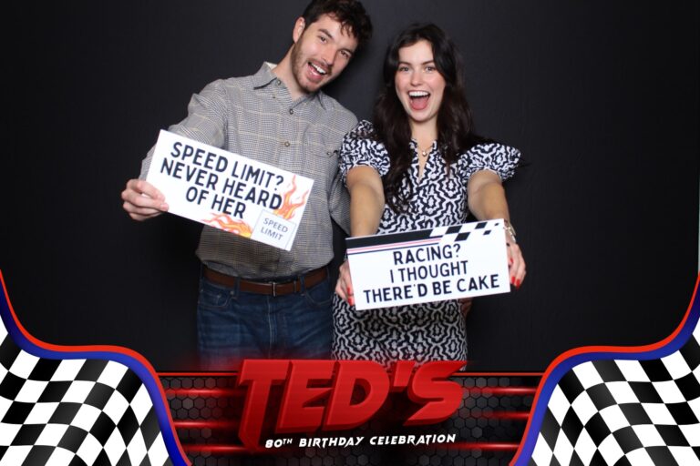 couple posing with custom signs