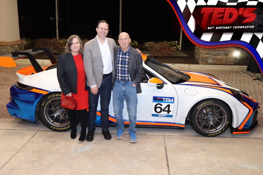 guess standing with race car posing with the cruise roamer